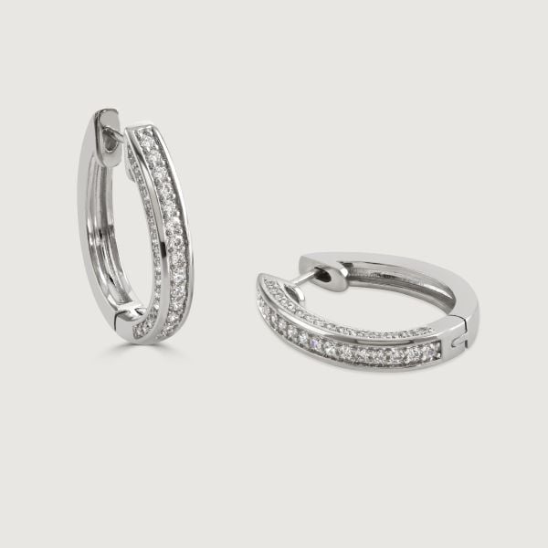 Elevate your style with the Pave and Polished Hoop. This timeless hoop design sparkles with cubic zirconia stones adorning one side, while the hinge onward showcases a sleek, polished band. A perfect blend of elegance and simplicity for a sophisticated lo