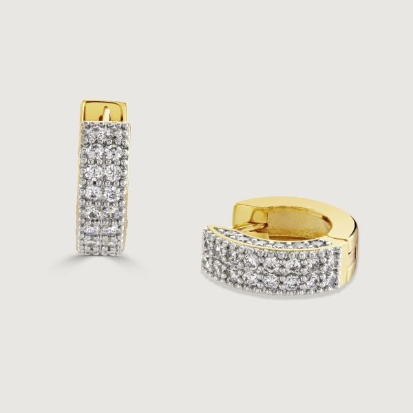Introducing our Pave Chubby Huggie Earrings: Luxurious and captivating. Embellished with cubic zirconia, the bold band sparkles till the hinge, elegantly transforming into a sleek polished hoop. Elevate your style with this seamless blend of opulence and 