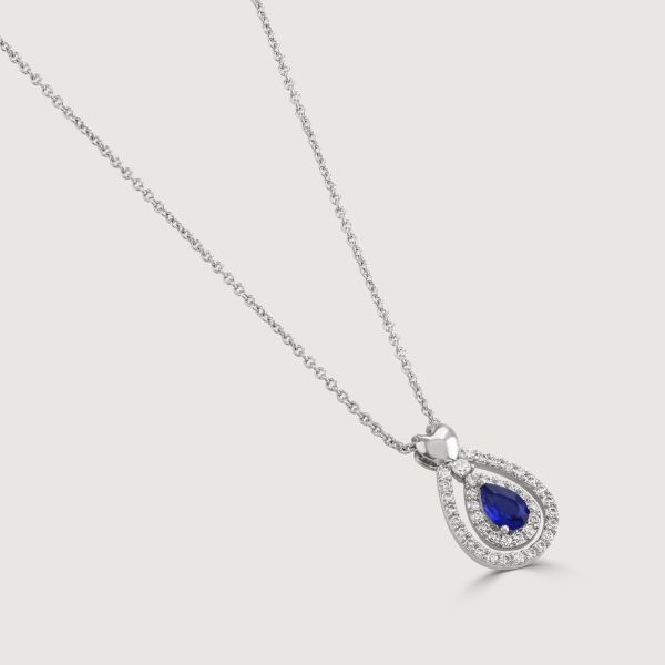 Discover elegance with our Sapphire Heart Pear-Drop Pendant. Enhanced by twin cubic zirconia pear-drop bands, it features a polished heart on the bale. The enchanting focal point is a captivating sapphire stone.