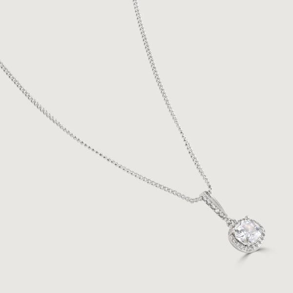 The Clear Cushion Drop Pendant is a enrapturing piece. Impeccably shaped cubic zirconia stones encircle a brilliant clear cushion cut centre, exuding a mesmerising allure. 
