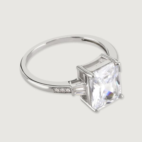 A stunning art deco inspired ring featuring an immaculate baguette cut central cubic zirconia stone, with tapered cubic zirconia baguette sides flawlessly faceted for maximum sparkle.