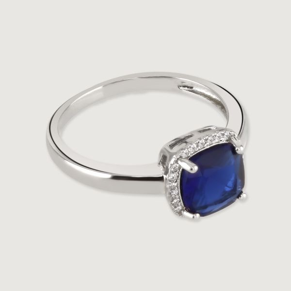 This beautiful ring is set with a halo of flawlessly cut cubic zirconia stones, surrounding a dazzling cushion cut, Sapphire coloured, centre stone. Wear to add timeless glamour to any look.